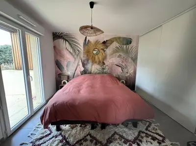 a bedroom with a large red bed with a mural at Maison Joepolly corsica in Bonifacio