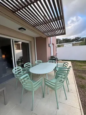 a table and chairs sitting on a patio at Maison Joepolly corsica in Bonifacio