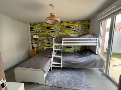 a bedroom with two bunk beds in a room at Maison Joepolly corsica in Bonifacio