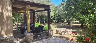 a park bench sitting in the middle of a garden at tour casella in Bonifacio