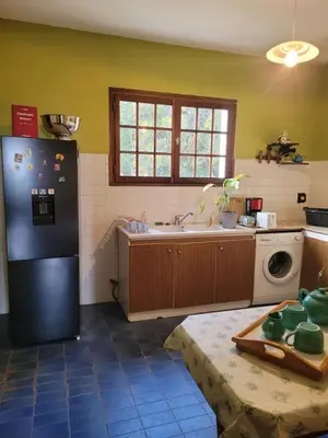 a kitchen with a black refrigerator and a sink at CASA DI SIGNARE in Ventiseri