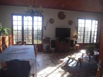 a living room with a table and a television at CASA DI SIGNARE in Ventiseri