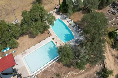 an overhead view of two large swimming pools at Location L'épi d'or Calvi, demeure de charme in Calvi