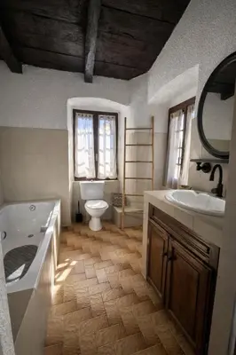a bathroom with a tub and a toilet and a sink at Location L'épi d'or Calvi, demeure de charme in Calvi