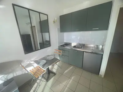 a kitchen with gray cabinets and a sink and a mirror at Studio 28 m2 PORTICCIO Centre in Porticcio