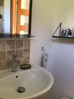 a white sink in a bathroom with a mirror at 1,2,3 soleil in Porticcio