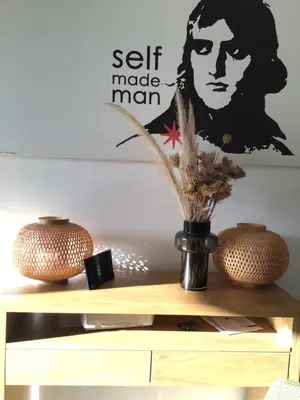 a vase on top of a shelf with a picture of a woman at 1,2,3 soleil in Porticcio