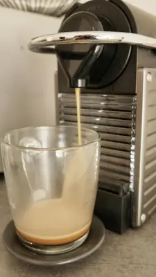 a coffee maker is making a cup of coffee at Capstay studio avec grande terrasse proche aéroport Bastia - Lucciana - Centre in Lucciana