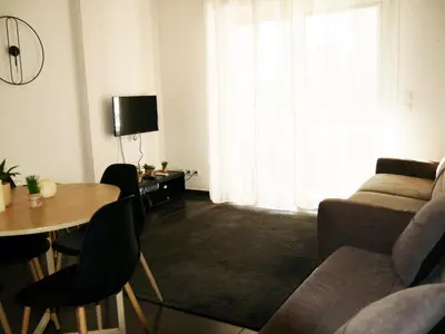 a living room with a couch and a table at Capstay studio avec grande terrasse proche aéroport Bastia - Lucciana - Centre in Lucciana