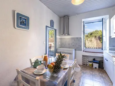 a kitchen and dining room with a table and chairs at Apartment Santa by Interhome in Porto-Vecchio