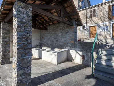 a stone building with a tub in a courtyard at Holiday Home Casa Serena by Interhome in San-Giuliano
