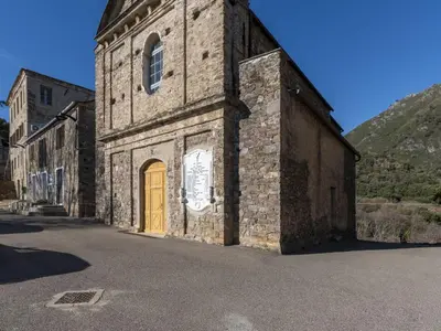 an old stone building with a yellow door on a street at Holiday Home Casa Serena by Interhome in San-Giuliano
