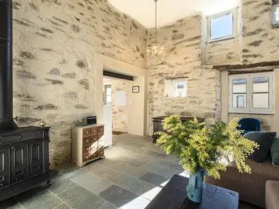 a living room with a wood stove and a couch at Holiday Home Casa Serena by Interhome in San-Giuliano