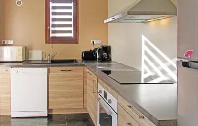 a kitchen with a sink and a stove top oven at Beautiful Home In Venzolasca With Wifi in Camp du Cap Sud