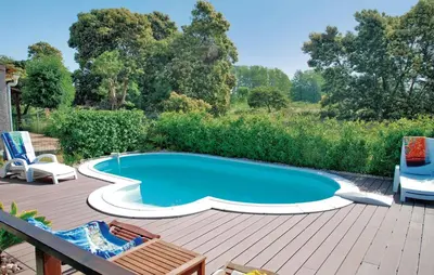 a swimming pool on a wooden deck with chairs around it at Beautiful Home In Venzolasca With Wifi in Camp du Cap Sud