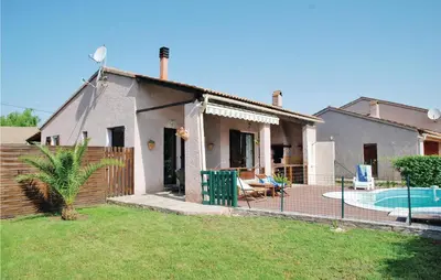 a house with a swimming pool in a yard at Beautiful Home In Venzolasca With Wifi in Camp du Cap Sud