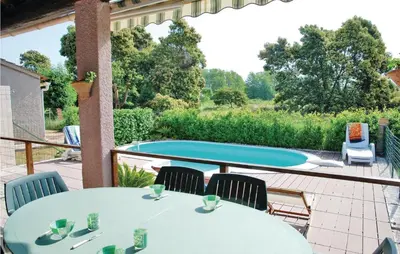 a patio with tables and chairs and a pool at Beautiful Home In Venzolasca With Wifi in Camp du Cap Sud