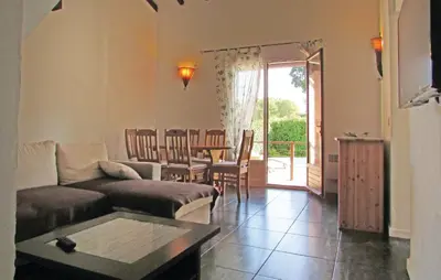 a living room with a couch and a table at Beautiful Home In Venzolasca With Wifi in Camp du Cap Sud