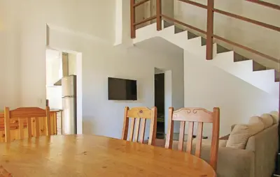 a dining room and kitchen with a table and chairs at Beautiful Home In Venzolasca With Wifi in Camp du Cap Sud