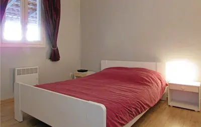 a bedroom with a white bed with a red blanket at Beautiful Home In Venzolasca With Wifi in Camp du Cap Sud