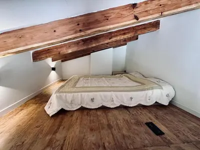 a bed in a room with a wooden ceiling at Casa Mare, CABANON SUR LA PLAGE à Ajaccio vue sanguinaires in Ajaccio