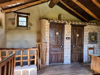 a room with a wooden door and a window at BERGERIE DE 1770 AVEC PISCINE in Sartène