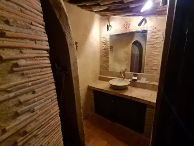 a bathroom with a sink and a mirror at BERGERIE DE 1770 AVEC PISCINE in Sartène