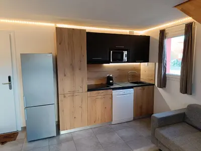 a kitchen with a refrigerator and a microwave at T3 Picchiarini, Clim, piscines, resto, 5' plages in Lecci