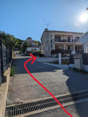 a red hose on a street with a house at I Tre Taglincchi, U Sicondu - Proche mer, Clim, Wifi, Parking gratuit in Taglio-Isolaccio