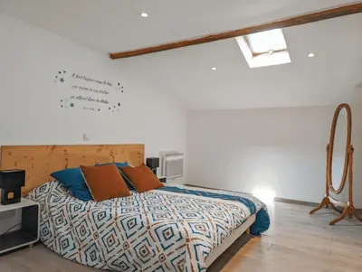 a bedroom with a bed in a white room at I Tre Taglincchi, U Terzu - Proche mer, Clim, Wifi, Parking gratuit in Taglio-Isolaccio