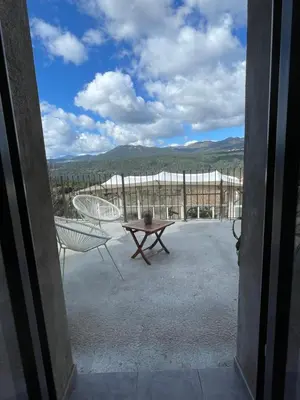 a view of a patio with a table and chairs at Très beau studio avec terrasse in Zonza
