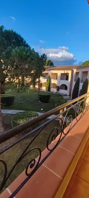 a metal railing on a balcony with a yard at appartement bord de mer en Corse avec 2 piscines 100 metres de la plage in Linguizzetta