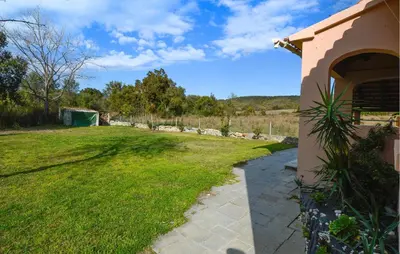 a walkway leading to a yard with a building at Casaperta Aleria in Pancheraccia