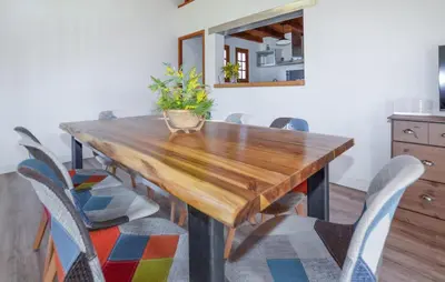 a dining room table with chairs and a mirror at Casaperta Aleria in Pancheraccia