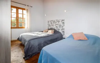 a bedroom with two beds and a window at Casaperta Aleria in Pancheraccia