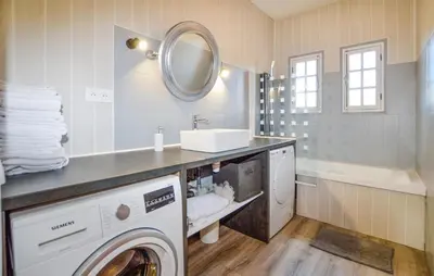 a bathroom with a washing machine and a sink at Casaperta Aleria in Pancheraccia