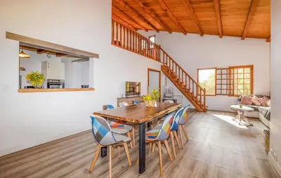 a dining room with a wooden table and chairs at Casaperta Aleria in Pancheraccia