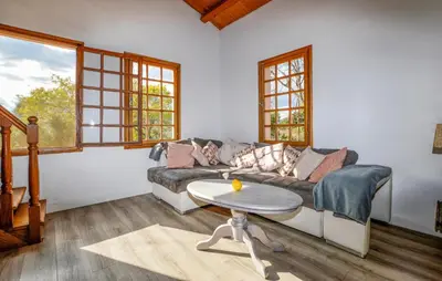 a living room with a couch and a table at Casaperta Aleria in Pancheraccia