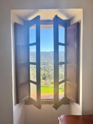 an open window with a view of a mountain at Maison de village calme et agréable in Albitreccia