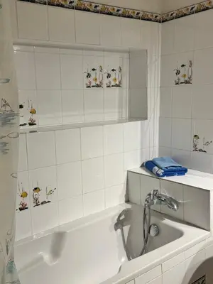 a white bathroom with a tub and a sink at Maison de village calme et agréable in Albitreccia