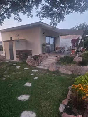 a small house with a garden and a patio at casasantellix in Prunelli-di-Fiumorbo