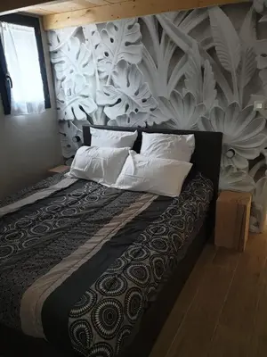 a bedroom with a large bed with white pillows at casasantellix in Prunelli-di-Fiumorbo