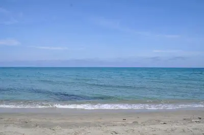 a view of the ocean from the beach at Studio en bord de mer sur Costa Serena N54 in Linguizzetta