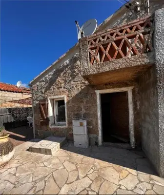 a stone building with two doors and a roof at Casa Calma - Maison à proximité des plages in Figari