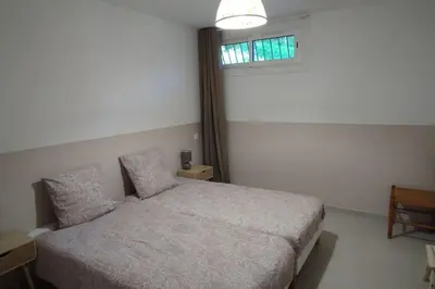 a small bedroom with a bed and a window at Charmant rez de villa, et sa terrasse à Ajaccio in Ajaccio