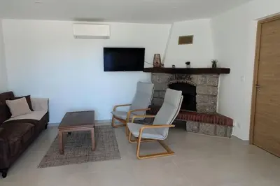 a living room with a couch and a fireplace at Charmant rez de villa, et sa terrasse à Ajaccio in Ajaccio