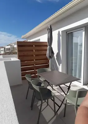 a patio with a table and chairs and an umbrella at T2 VUE MER MARINA DI BRAVONE N197 in Linguizzetta