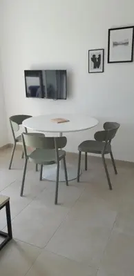 a table and two chairs and a white table and chairs at T2 VUE MER MARINA DI BRAVONE N197 in Linguizzetta