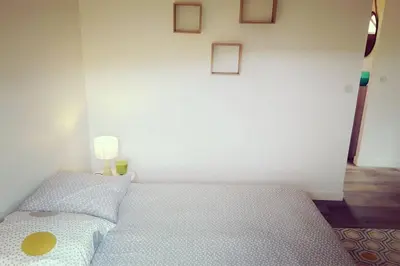a bedroom with a bed with a yellow circle on it at Magnifique bergerie corse du 17eme Siècle à proximité des plages in Eccica-Suarella