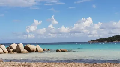 a group of rocks in the water on a beach at A VIGNA VECCHIA chambre d'hôtes in Porto-Vecchio